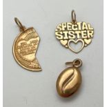3 yellow metal pendants/charms. A coffee bean, "Special Sister" heart shaped pendant and a half