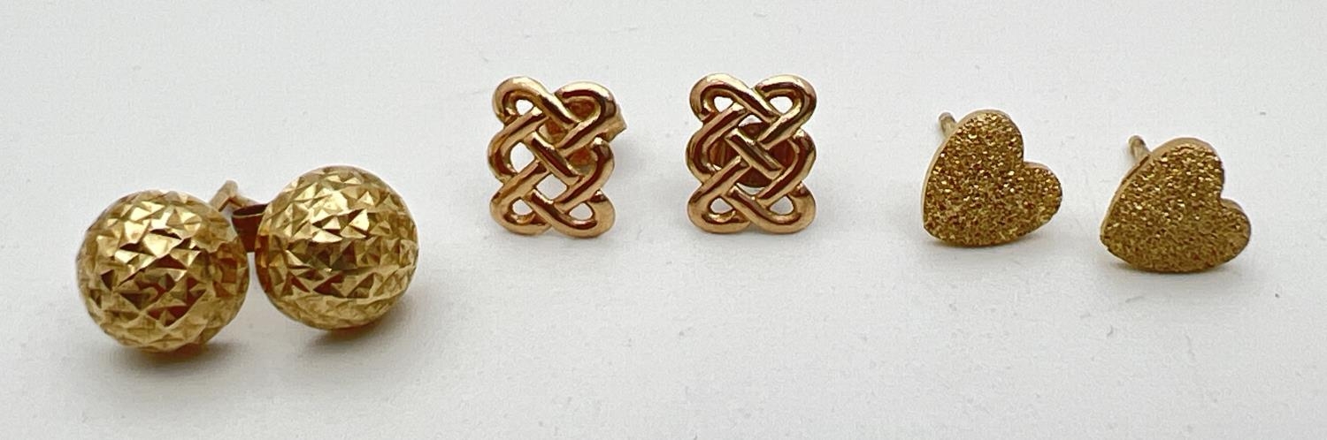 3 pairs of gold and yellow metal stud style earrings to include a pair of stardust hearts and Celtic