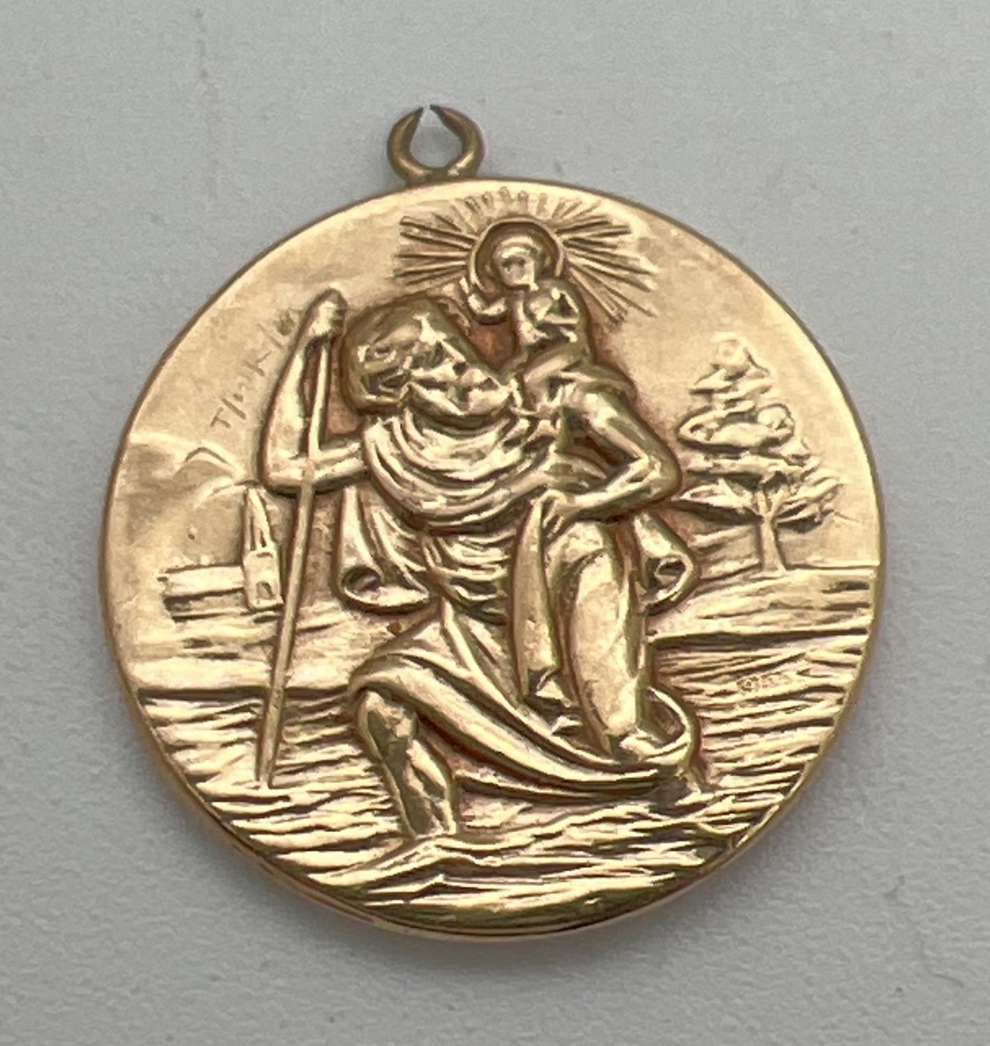 A vintage 9ct gold St. Christopher pendant with train, plane, car and ship detail to back. Fully