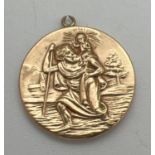 A vintage 9ct gold St. Christopher pendant with train, plane, car and ship detail to back. Fully