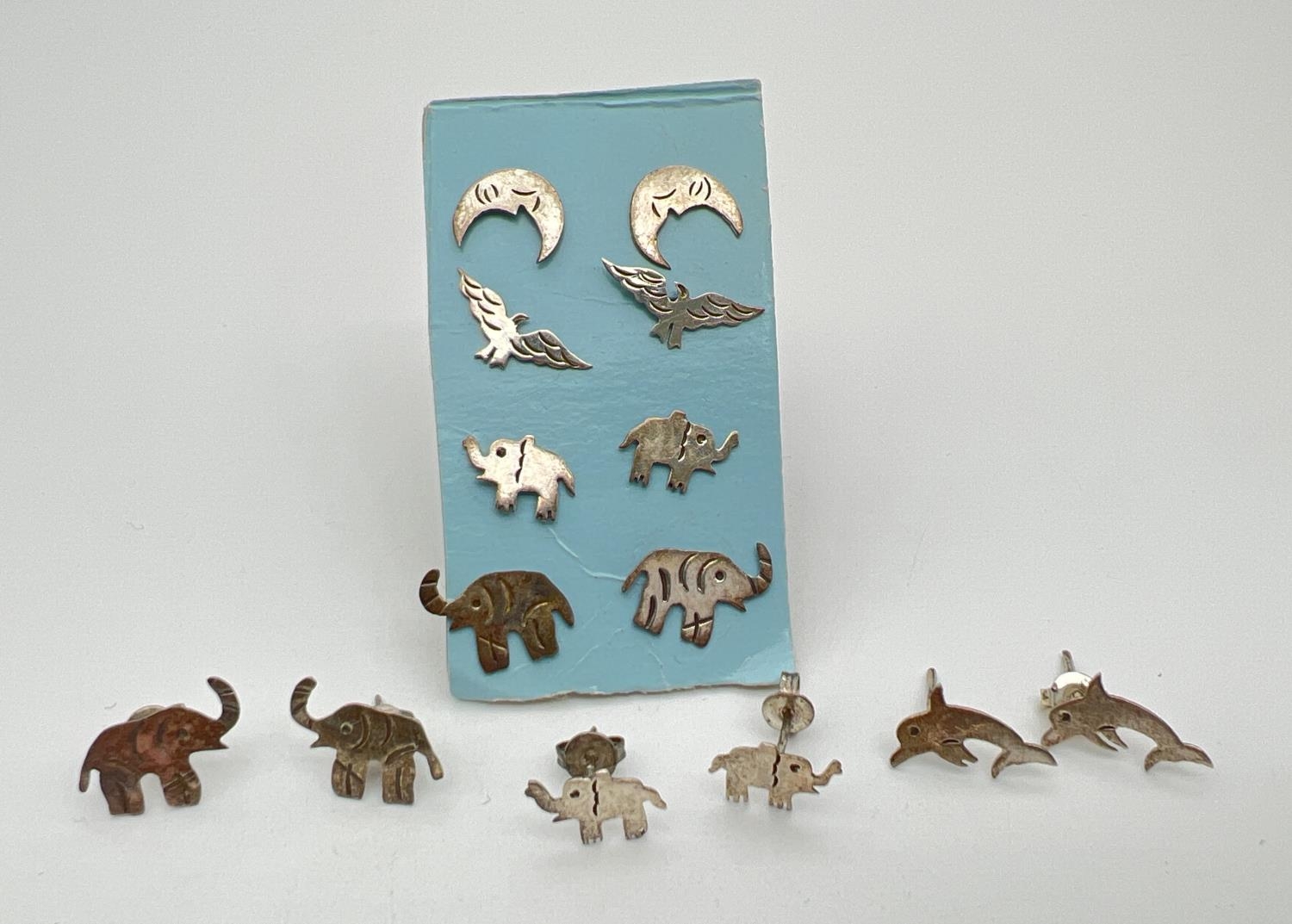 7 pairs of white metal animal and bird shaped stud style earrings. To include elephants, dolphins