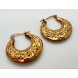 A pair of 9ct gold creole style earrings with floral pattern and hinged posts. Approx. 2.75cm