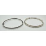 2 silver bangles, both with push clasps and safety clips. One with illusion stardust detail the