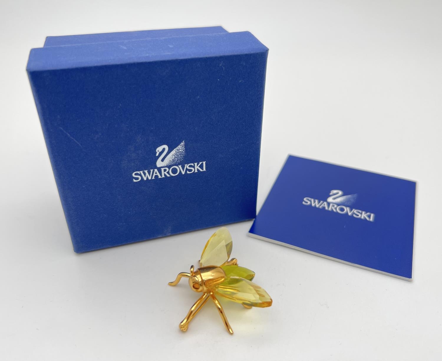 A boxed Swarovski Crystal flying insect brooch from the 'Paradise Bugs' range. Gold plated silver