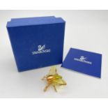 A boxed Swarovski Crystal flying insect brooch from the 'Paradise Bugs' range. Gold plated silver