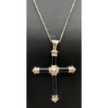 A black onyx and silver cross pendant on a 19 inch fine curb chain with spring clasp. Silver marks