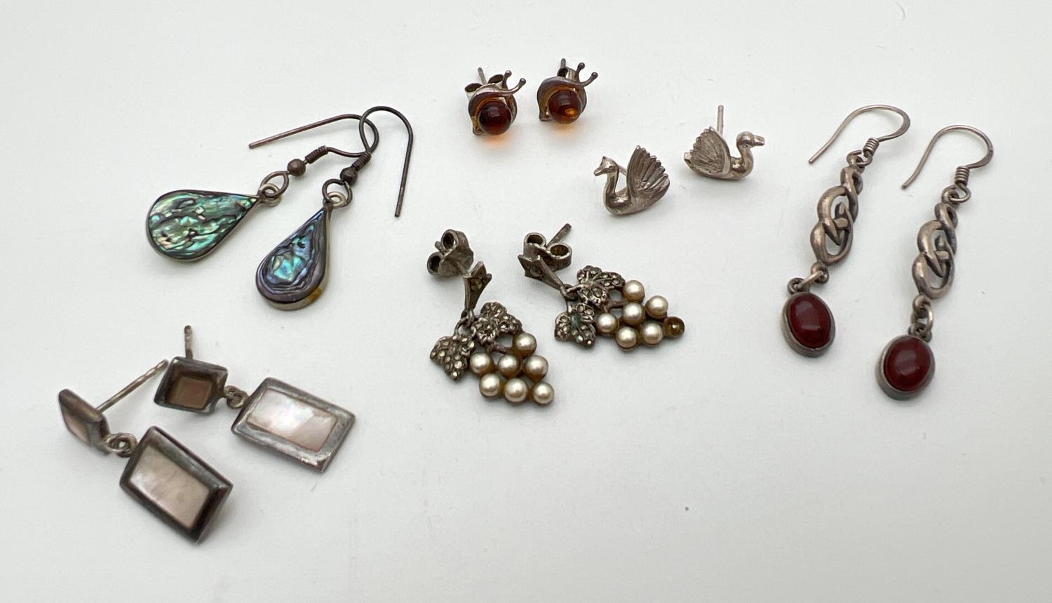 6 pairs of silver and white metal stud and drop style earrings. To include marcasite and faux