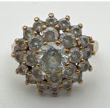 A 9ct gold and cubic zirconia large cluster ring. Central round cut stone surrounded by 2 rows of