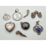8 small silver and white metal pendants/charms. To include a heart shaped locket, Comedy and Tragedy