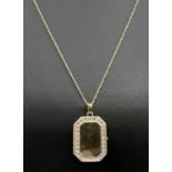 A rectangular shaped 9ct gold locket with small stone mount detail to edges (no stones). On an 18"
