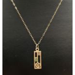 An unmarked gold Rennie Mackintosh rose design rectangular pendant on a 16" fine belcher chain