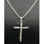 A silver cross shaped pendant set with marcasite stones, on a 17" fine snake chain with lobster claw