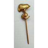 A 9ct gold Snoopy stick pin brooch. Gold marks to back of pin, approx. 4.25cm long. Total weight