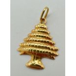 An 18ct gold pendant in the shape of a tree. Gold mark to hanging bale. Approx. 3cm x 2cm (including