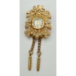 A gold tone Cuckoo clock pendant/brooch set with clear stones, by ETC Co. Ltd. Floral and bird