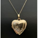 A 9ct gold heart shaped locket with floral detail to front, on an 18" fine belcher chain with spring