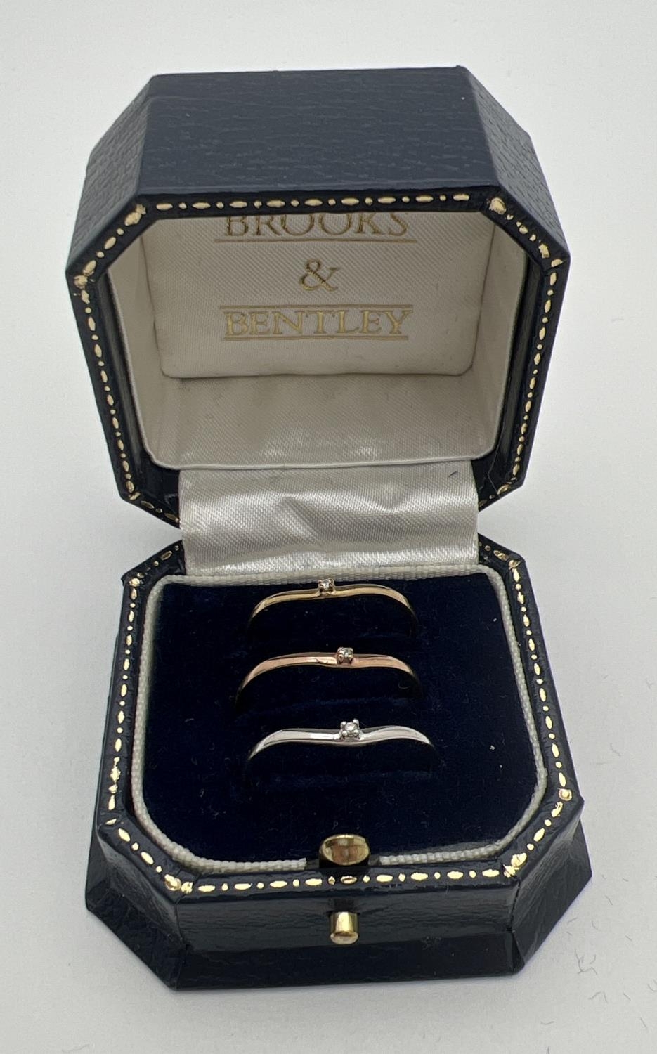 A boxed 9ct gold "Celtic Dreams" triple stacking ring set. 3 wishbone style rings each set with a