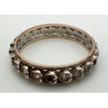 A vintage 9ct gold & silver full eternity ring set with small round cut clear stones. In heart