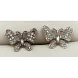 A pair of 9ct white gold butterfly stud style earrings. Each set with 33 small round cut diamonds (