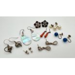 8 pairs of vintage and modern design silver and white metal earrings. To include large flower studs,