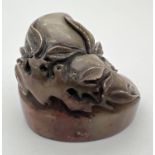 A small Chinese soapstone oval shaped seal with carved detail of fruits & leaves. Approx. 4cm tall.