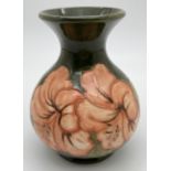 A vintage Moorcroft Hibiscus pattern vase of bulbous form, with green ground and coral coloured