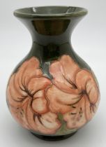 A vintage Moorcroft Hibiscus pattern vase of bulbous form, with green ground and coral coloured