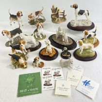 A collection of assorted collectable resin dog figurines, mostly Beagles, Fox Hounds & Highland