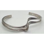 A silver modern design double wave style cuff bangle. Silver marks to inside. Total weight approx.