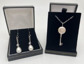 A 925 silver key shaped pendant set with 13mm pearl, on a 17" chain, together with a pair of