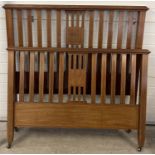 An Edwardian double bed frame with inlaid detail, slatted head & foot board, complete with bed