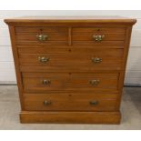 An Edwardian satin wood 2 over 3 chest of drawers with brass drop down handles. Approx. 106cm tall x
