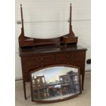 An Edwardian satin wood dressing table with inlaid detail, tapered legs and brass caster feet. Curve