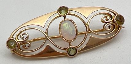 A Merrle Bennet Art Nouveau 15ct gold brooch set with central oval cut opal and 4 small round cut