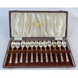 A cased set of 12 silver teaspoons with Art Deco design handles in original W. R. Bullen, Norwich