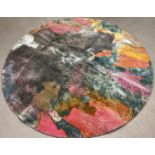 A large modern multi-coloured circular shaped rug from the Aria Collection. Blue - grey ground