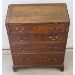 An antique walnut 4 drawer bureau with internal stationery compartments and brass drop down handles.
