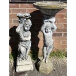 A tall concrete garden bird bath with pedestal base modelled as young child of classical design,