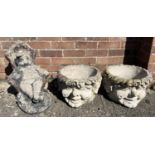 A pair of concrete garden planters modelled as gnome heads together with a garden ornament of a