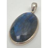 A large oval silver pendant set with a faceted Labradorite stone. Silver marks to bale, Approx. 5.
