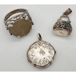 3 vintage silver items. A locket with engraved foliate design to front, stamped silver to reverse; a