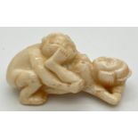 A small carved erotic netsuke with polished finish and signature to underside. Approx. 5cm long.