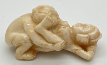 A small carved erotic netsuke with polished finish and signature to underside. Approx. 5cm long.