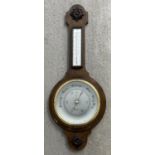 A large vintage dark wood Shortland Smiths banjo barometer with thermometer. Carved applied panels