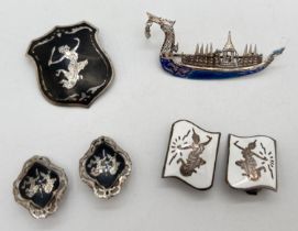 4 items of Siam silver jewellery. A dragon boat brooch with blue enamel detail; and a brooch, a pair