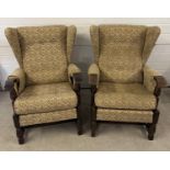 A pair of vintage 1930's dark oak framed wing back chairs with floral design upholstery and turned