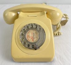 A vintage cream coloured GPO 746 rotary telephone with original tag to handset lead.