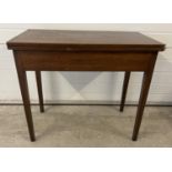 A vintage dark oak fold over tea table with square shaped taped legs and gate leg support. Approx.