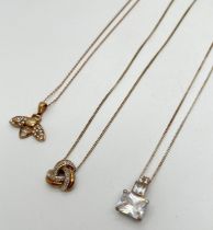 3 silver and silver gilt necklaces. A modern square shaped pendant set with clear stones, on a