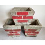3 vintage concrete square shaped garden planters with brick wall design sides. Painted red detail, a